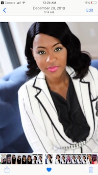 a woman in a white blazer and pink lipstick